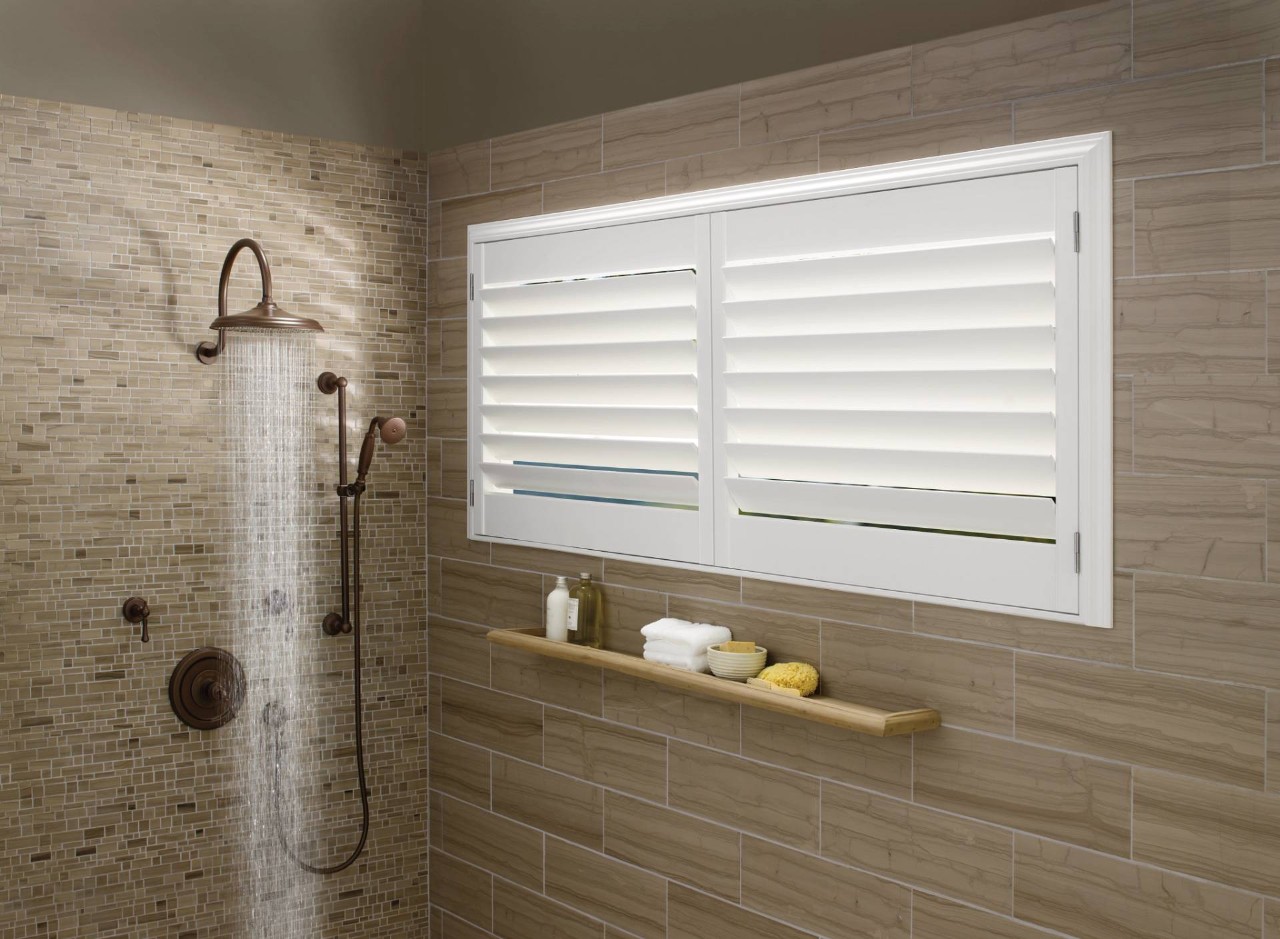 Hunter Douglas Palm Beach™ Polysatin™ vinyl shutters in a bathroom shower near the City of Industry, CA